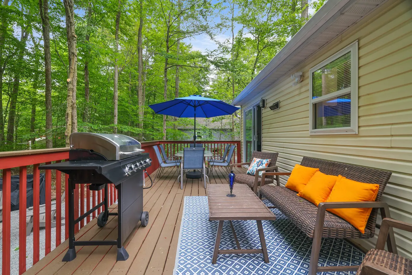The deck and fire pit at 243 Paxinos, a lakefront home at Arrowhead Lake
