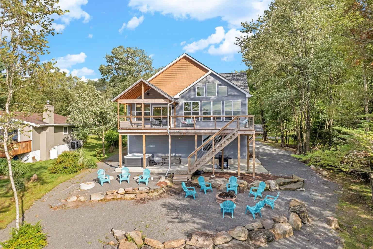 Adirondack chairs on the deck of a lakefront home at Arrowhead Lake