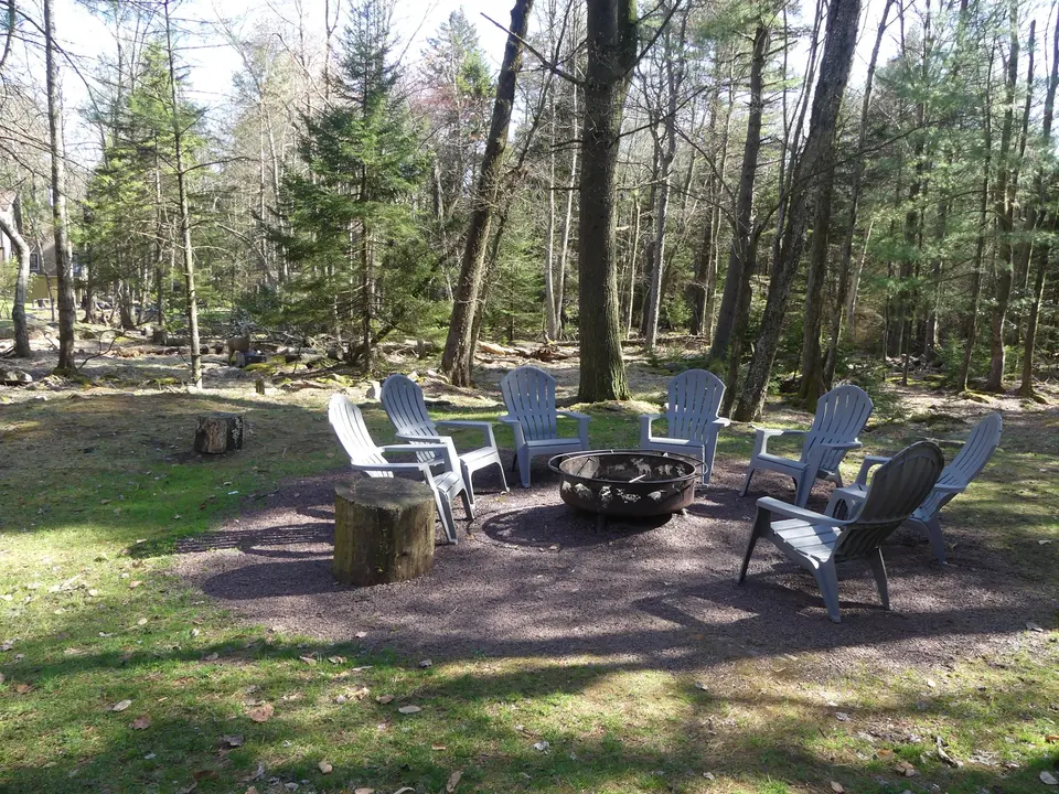 A home Ideal manages at Lake Harmony, with Adirondack chairs around the fire pit