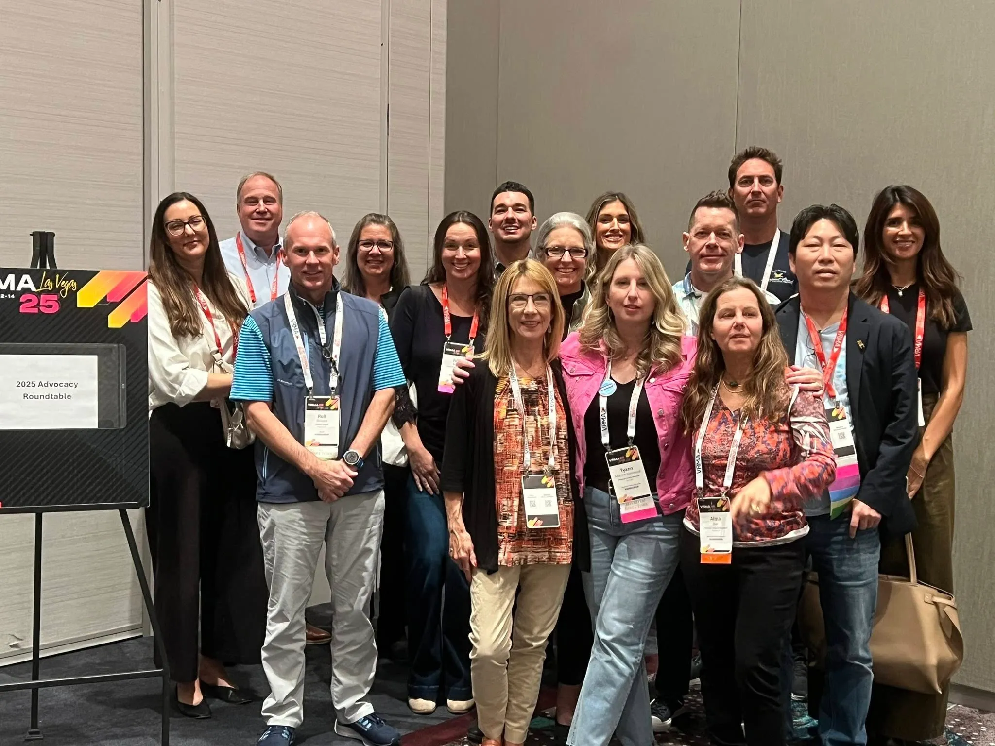 A group of people posing together at a conference beside a sign reading 2025 Advocacy Roundtable, from the Poconos Association of Vacation Rental Owners advocacy page