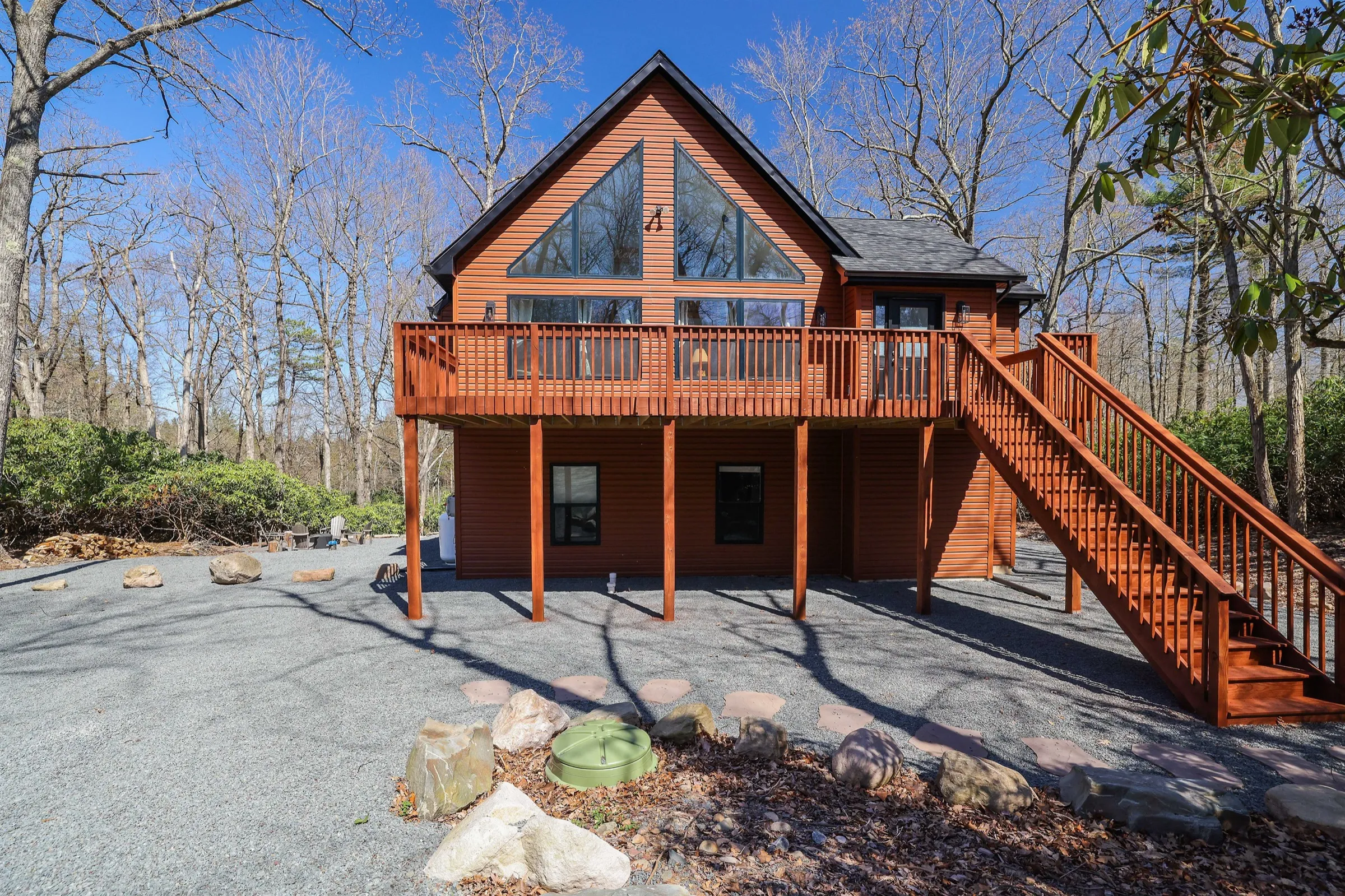 The Cedar & Stone Lodge, a home Ideal manages in Lake Harmony, with its deck and stairs